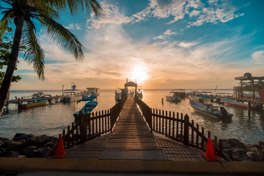 pier going out into ocean at sunset